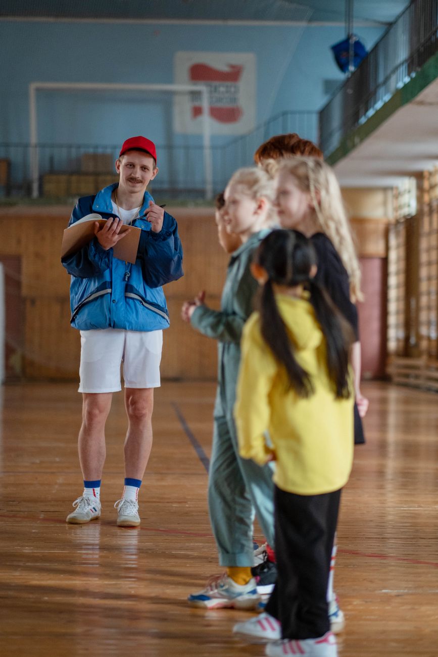 Children standing in an indoor sports hall